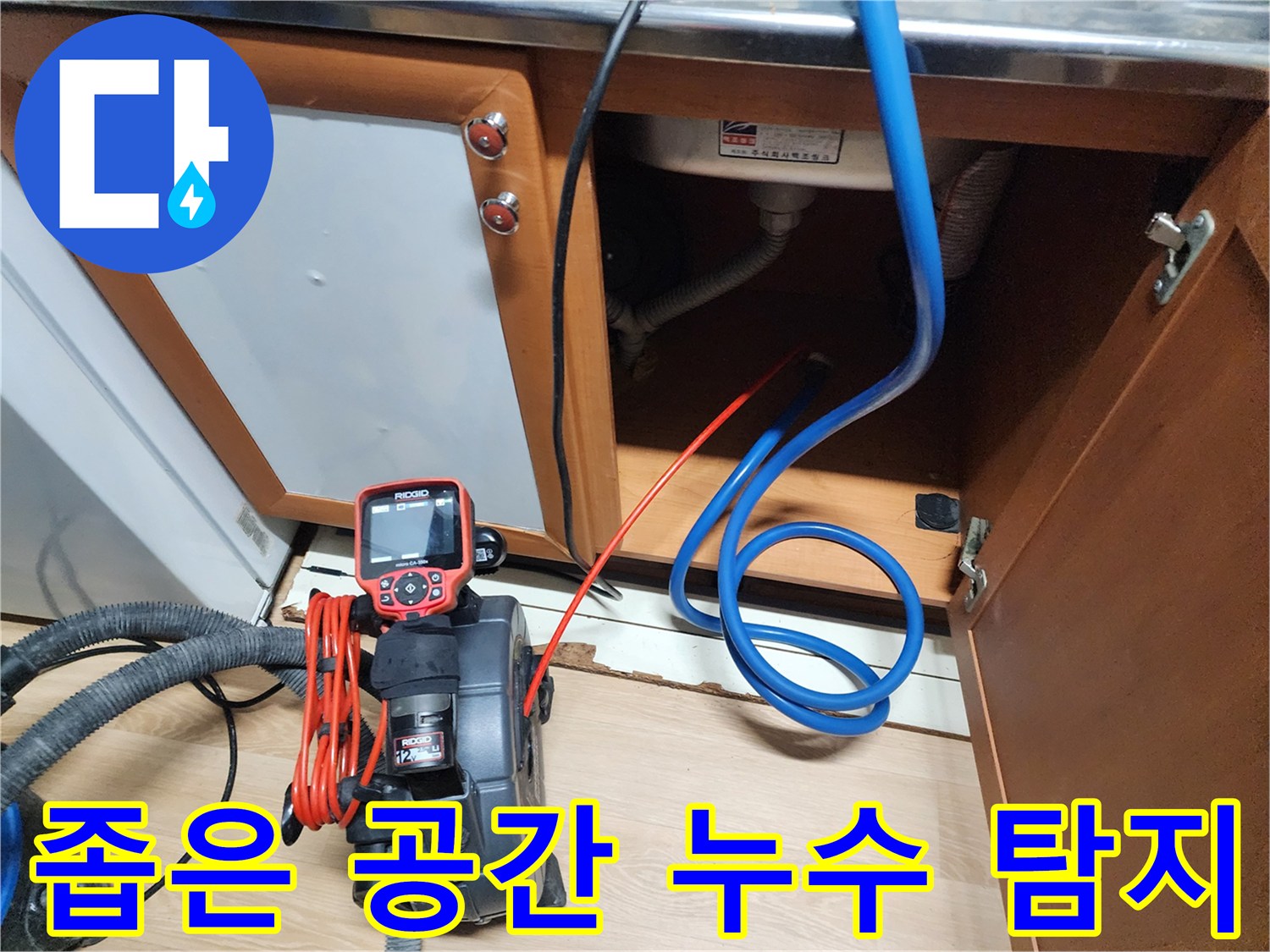 싱크대 아래 좁은 공간에서 누수 탐지 장비를 사용하여 - 꼼꼼하게 누수를 확인하고 있습니다.