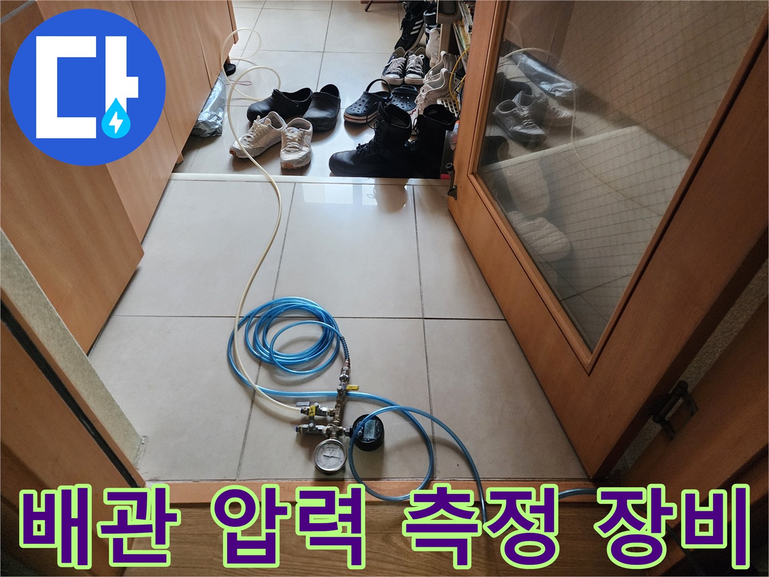 바닥에 놓인 파란색 에어 호스와 수치 표시 게이지