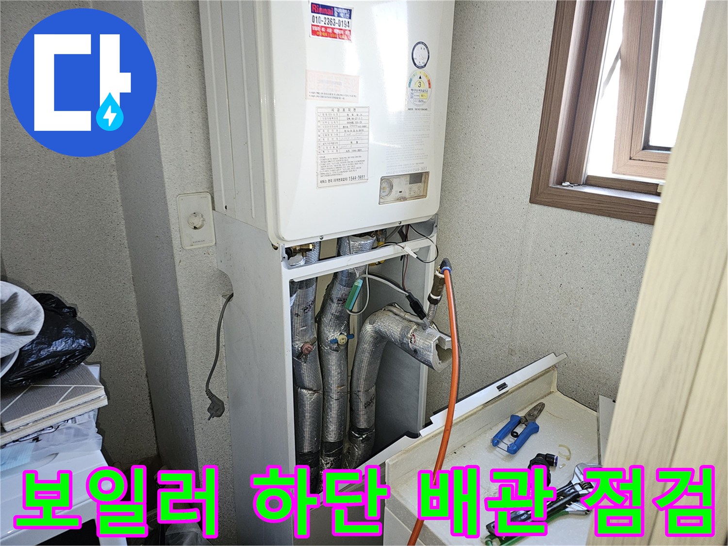 보일러-하단부-노출된-배관-및-공구-상태