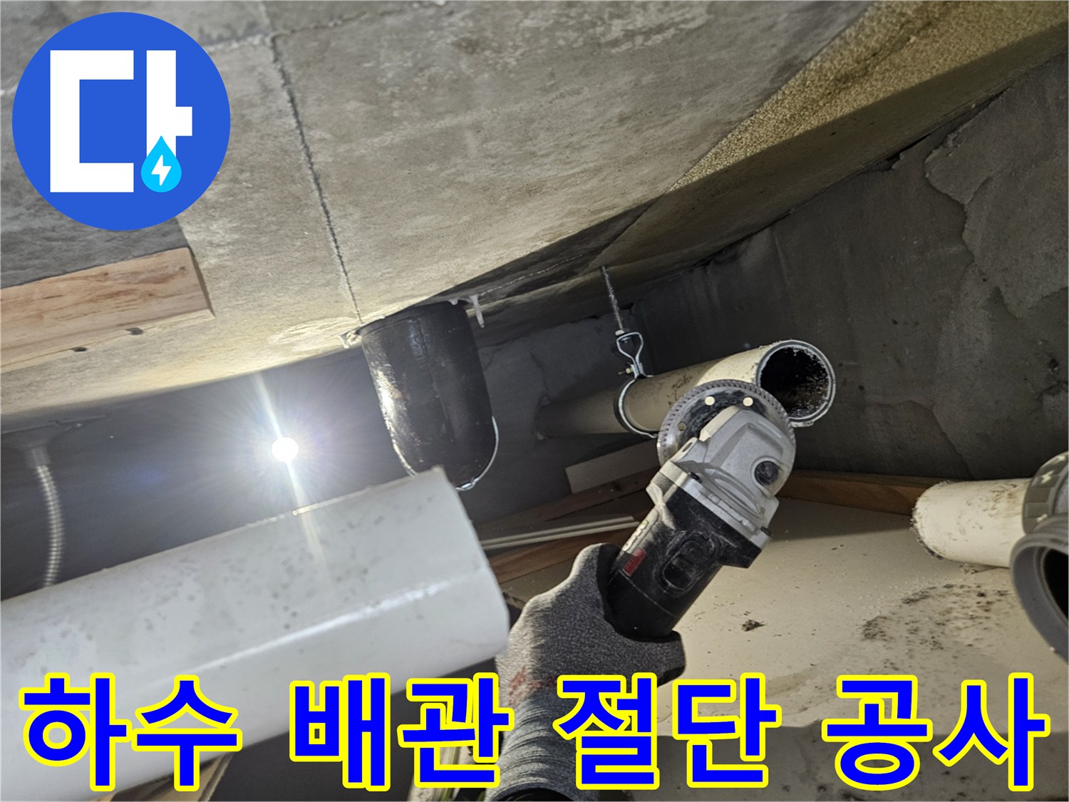 천장 속 하수 배관을 제거하기 위해 절단기를 사용 중인 작업 현장