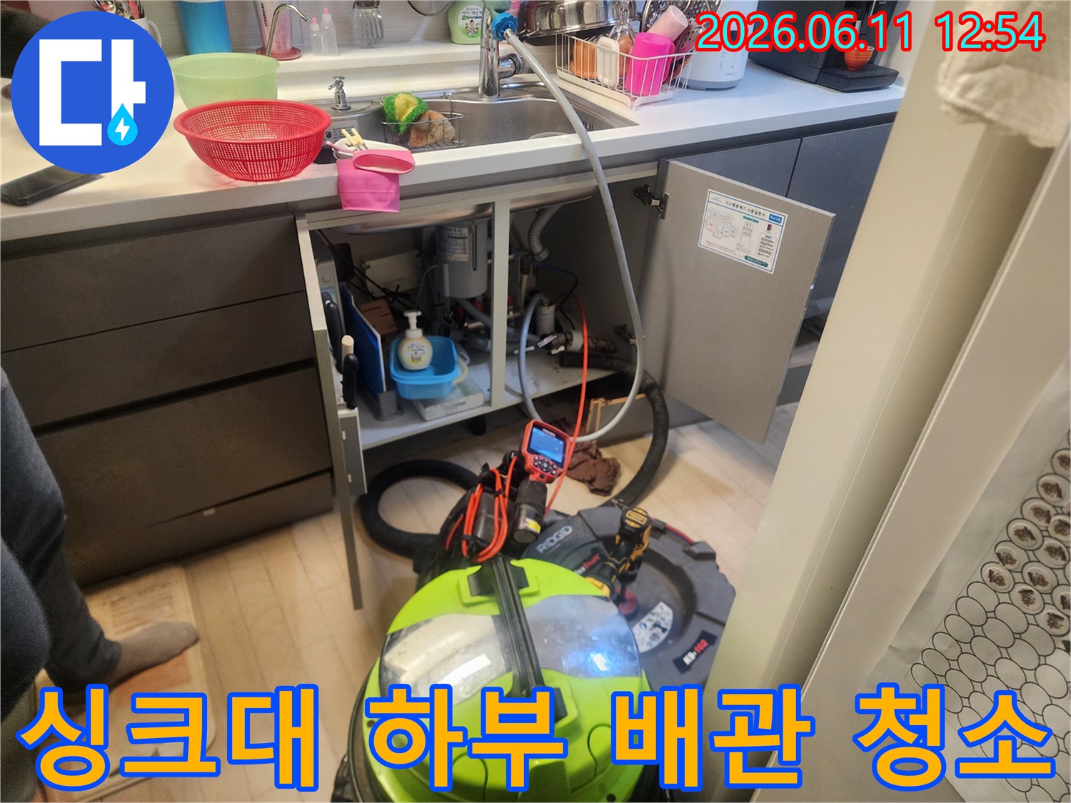 싱크대 하부장 내부의 배관 스케일링 작업 및 석션 장비 가동 모습