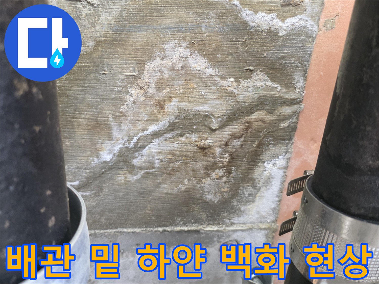 검은색 배관 주변에 넓게 퍼진 하얀색 석회 자국