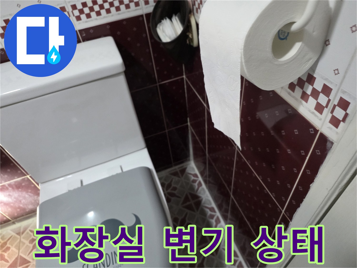 변기 주변의 타일과 휴지걸이 모습
