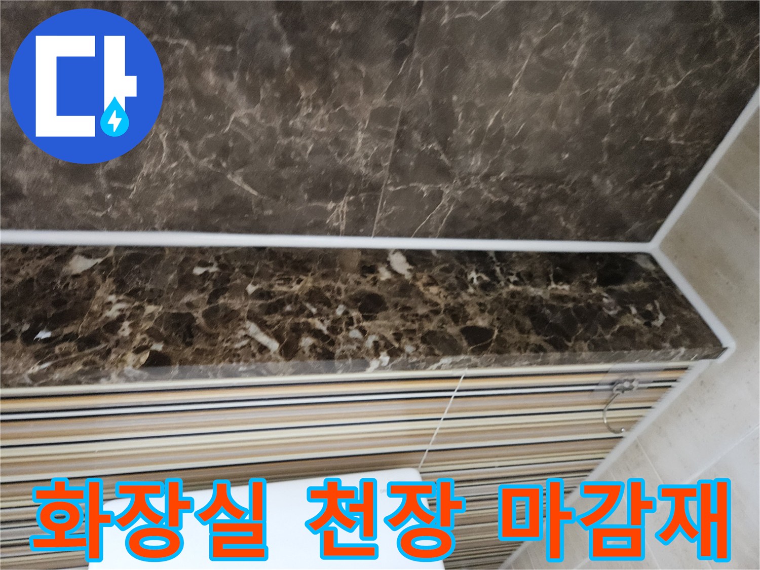 짙은 갈색 대리석 패턴의 화장실 천장재 모습입니다.