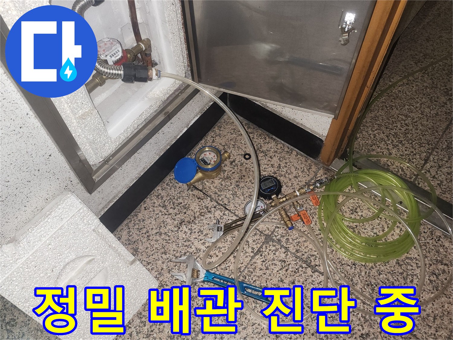 배관 연결부에 설치된 압력 측정 장비와 작업 도구
