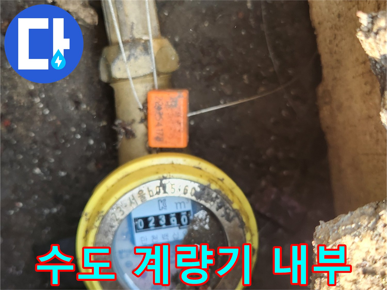 흙으로 덮인 계량기함 내부의 배관과 계량기 모습