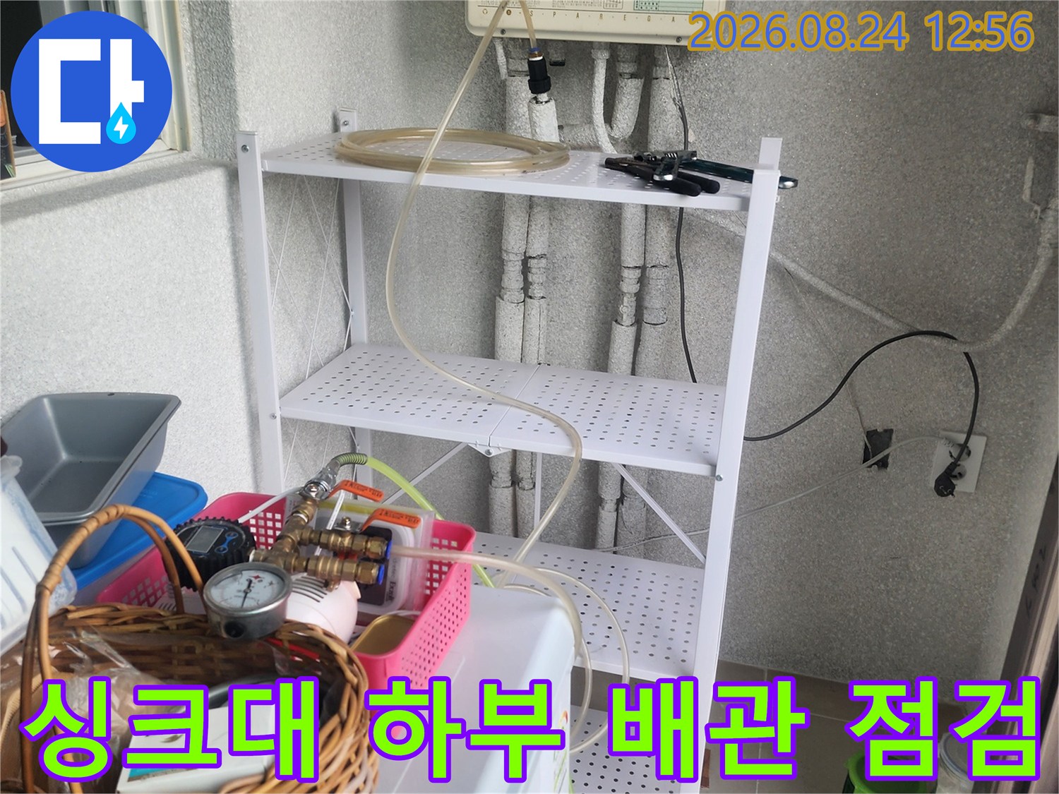 싱크대 아래쪽-배관과 장비가 설치된 모습