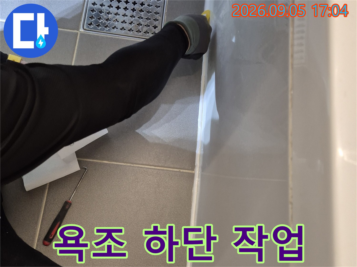 점검구를 통해 욕조 아래 배관의 파손 및 이탈 상태를 확인하는 모습입니다.